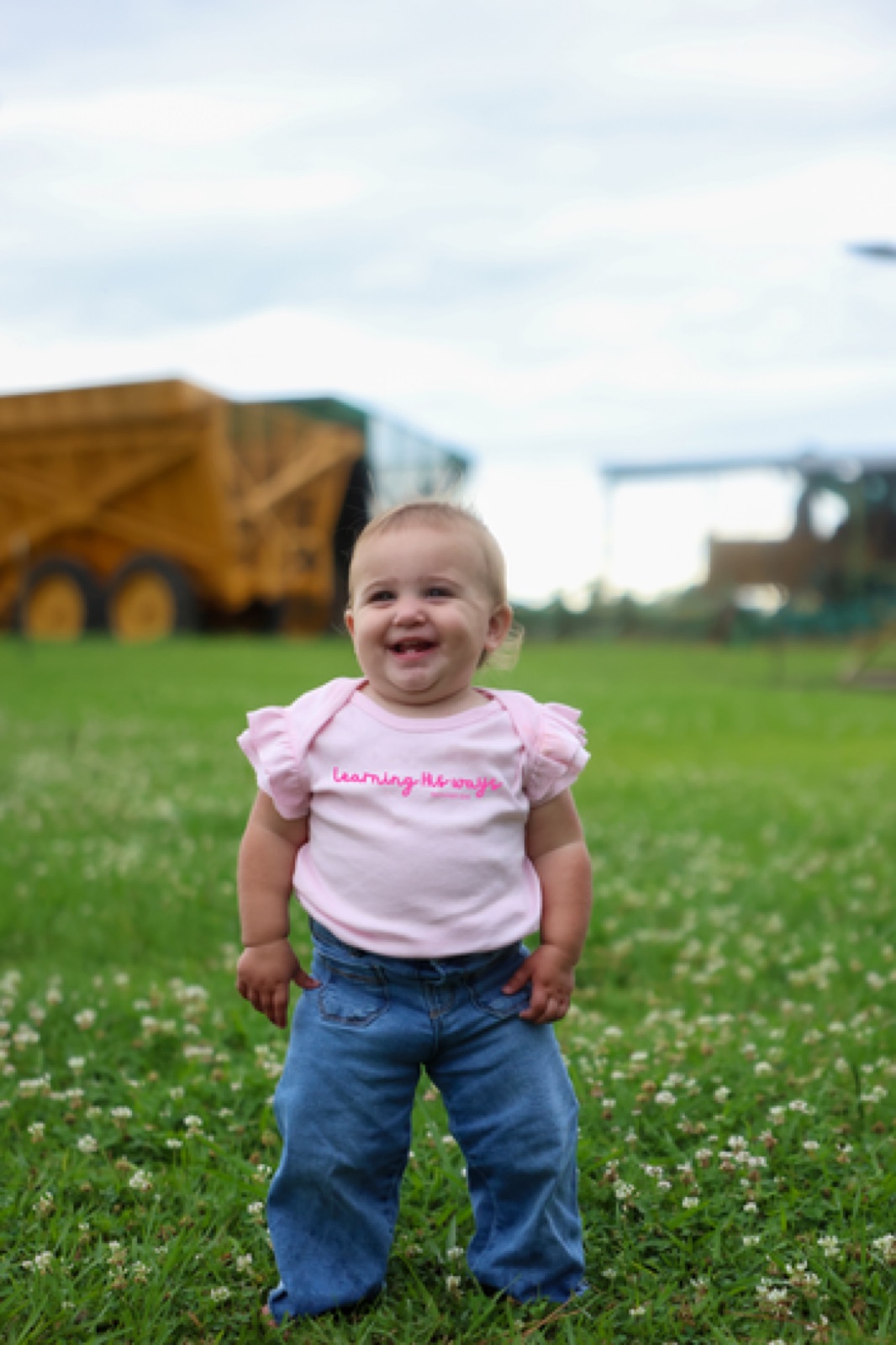 A baby wearing the pink Learning His Ways ruffle-sleeve onesie