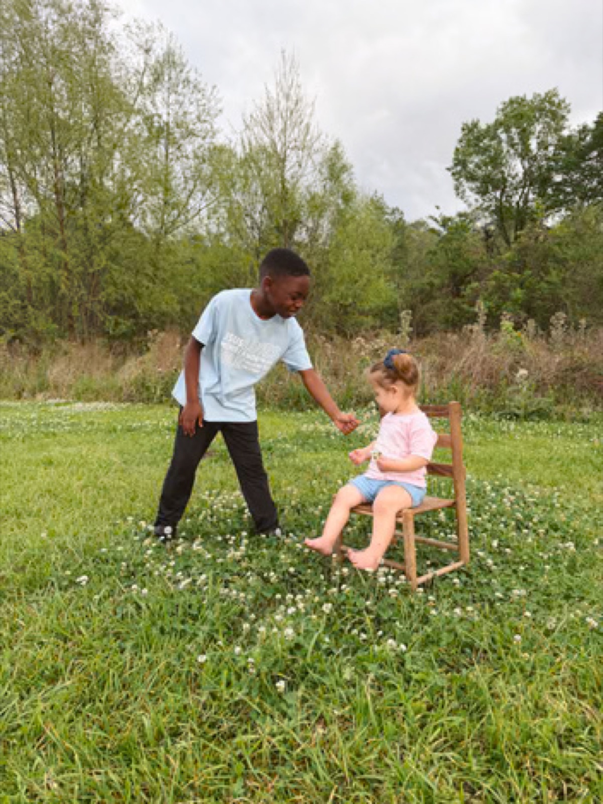 Two children sharing a moment outdoors in CROWND apparel